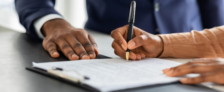 image of a person signing a document